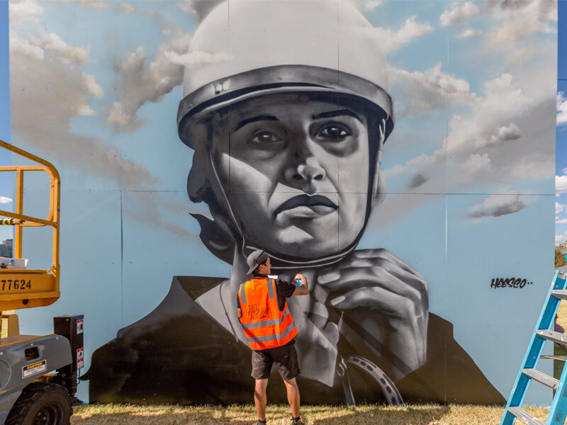 Heesco works on a a public mural